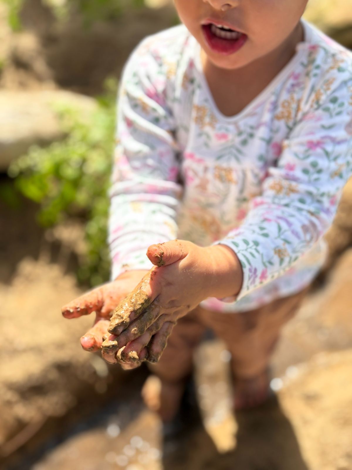 Child exploring mud and natural materials at Beginnings Forest Montessori Dubai