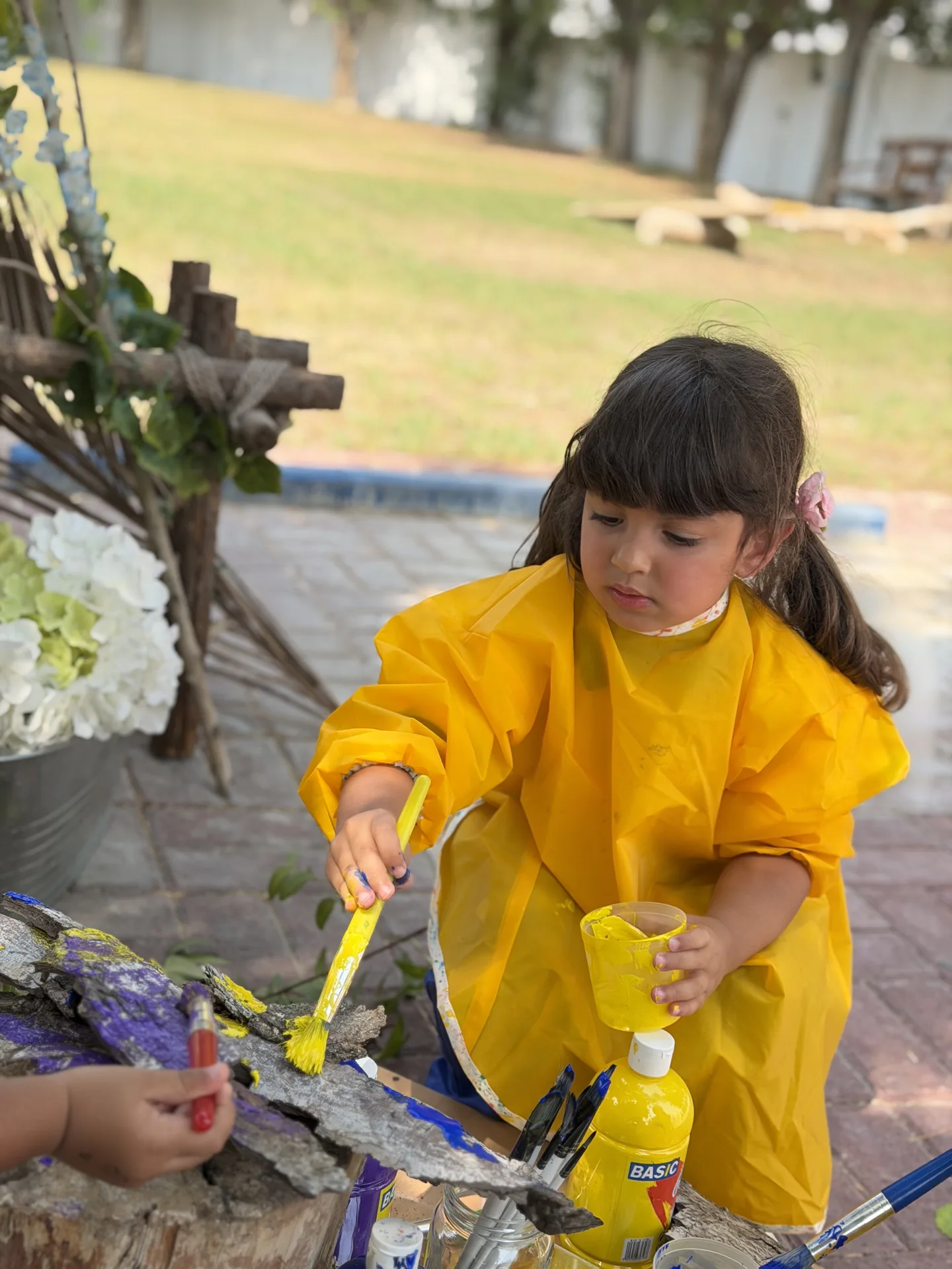 Focused outdoor painting portrait | Beginnings Forest Montessori Dubai Focused outdoor painting portrait at Beginnings Forest Montessori in Muhaisnah, Dubai.