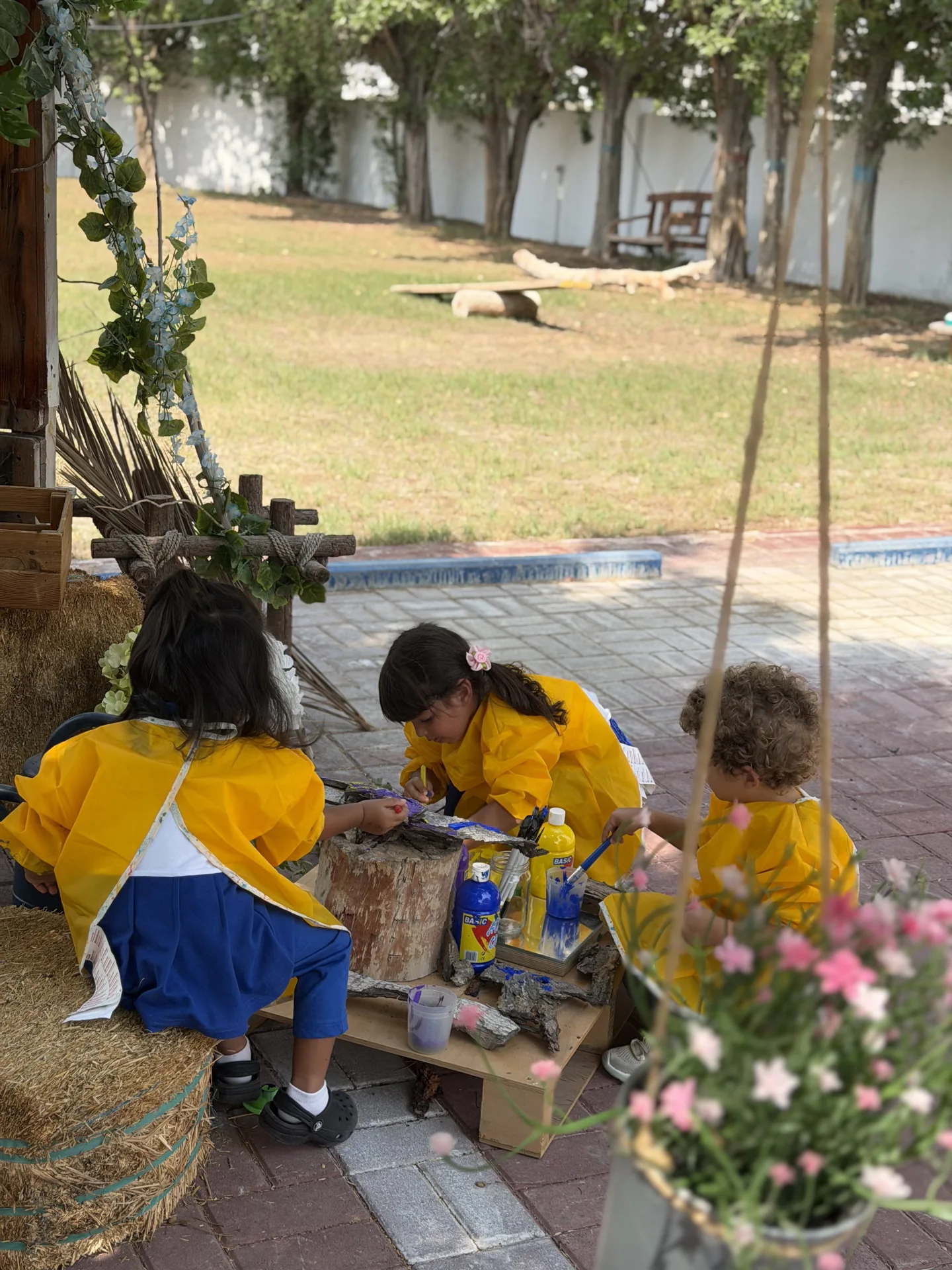 Outdoor collaborative art with natural materials at Beginnings Forest Montessori in Muhaisnah, Dubai.