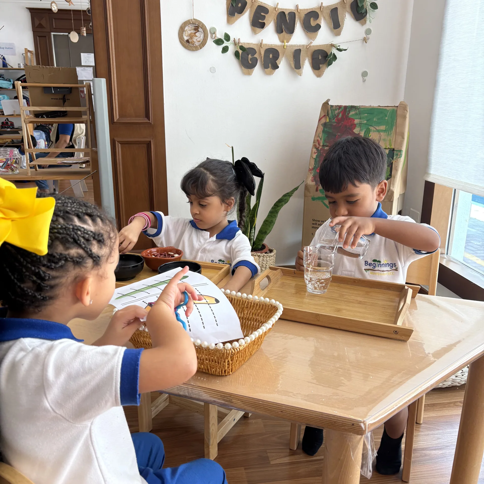Pouring and practical-life independence at Beginnings Forest Montessori in Muhaisnah, Dubai.